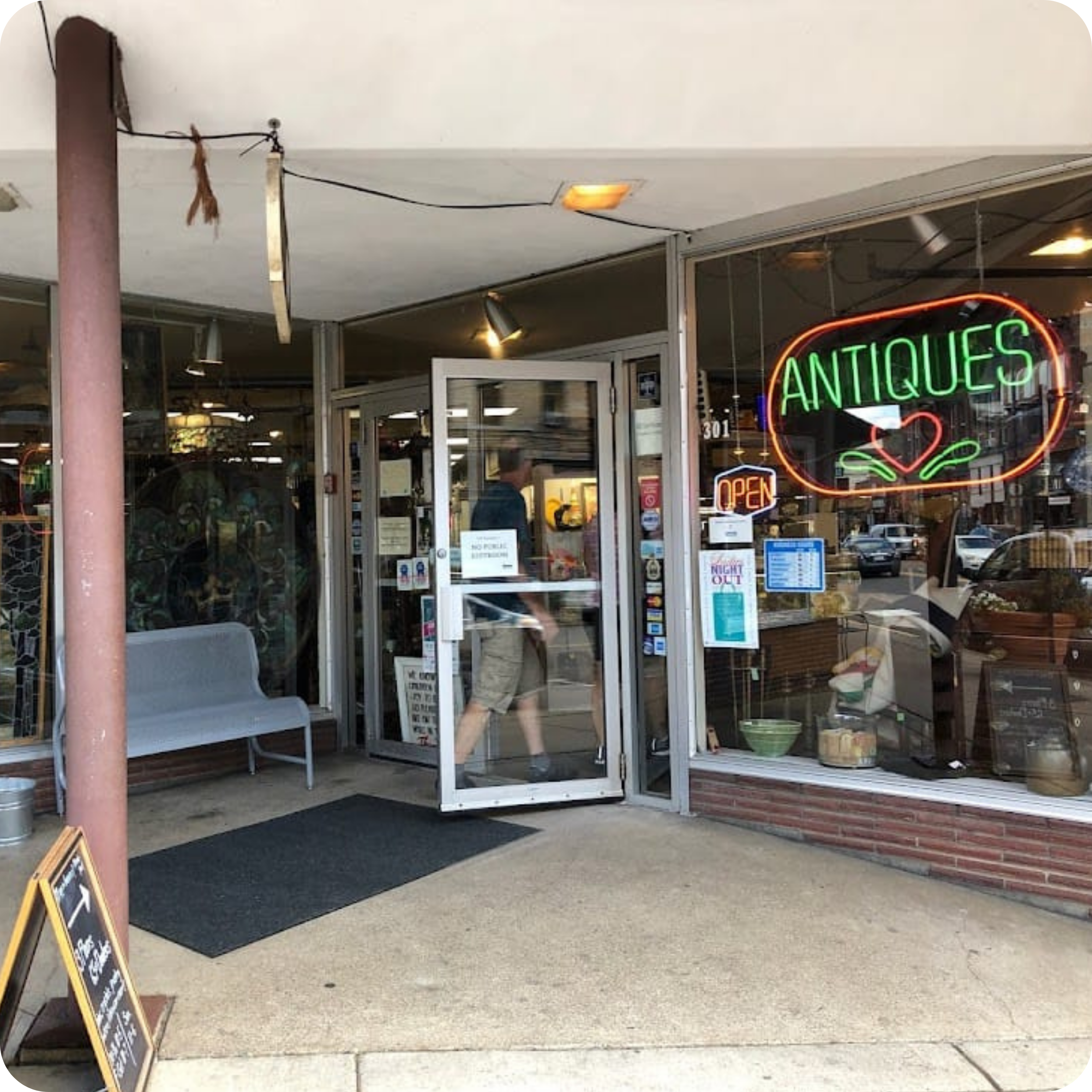 Entrance of an antique shop on Main Street in Stillwater, MN, featuring a neon 